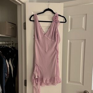 Elegant Pink Ruffled Dress with Floral Accent